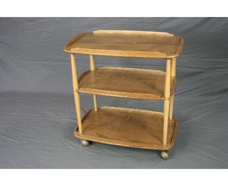 A BLONDE ERCOL ELM THREE TIER TEA TROLLEY, with galleried top, approximate size width 68cm x height 75cm x depth 46cm