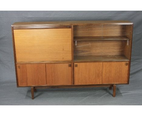 ROBERT HERITAGE, BEAVER & TAPLEY TEAK BOOKCASE/COCKTAIL CABINET, with combination of wooden and glazed sliding doors, a fall 