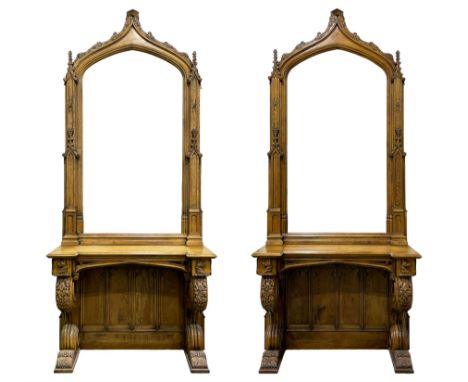 Pair Gothic style oak console table with mirror, pointed ogee arch decorated with trailing scrolled foliage, the tracery upri