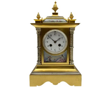 Early 20th century French mantle clock in a brass satin finished case with contrasting silvered detail, canted ogee top surmo