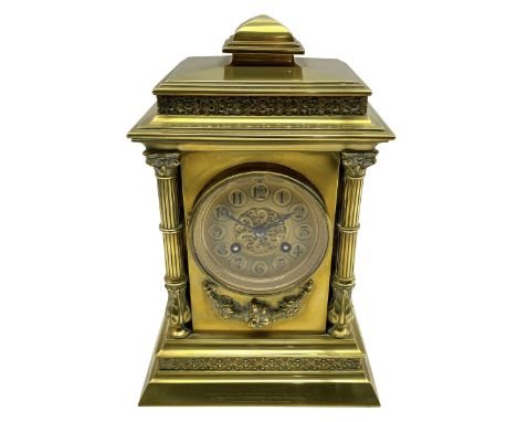 Brass cased eight-day French mantle clock c 1910, with a stepped pediment and applied decorative frieze, recessed reeded pill
