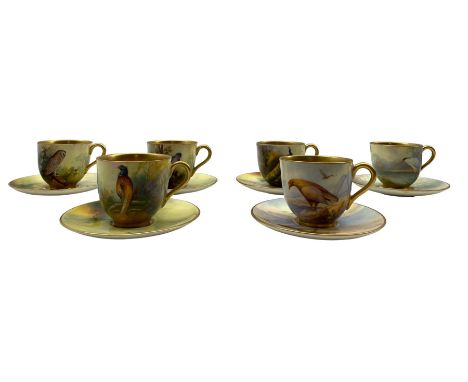 Six Royal Worcester coffee cups and saucers by Albert Shuck and Reginald Austin, the cups painted with birds in a landcape in