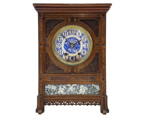 Carved oak cased 8-day striking and chiming mantle clock in the style of William Morris c1880, rectangular case raised on fou