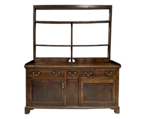 Georgian oak dresser, the two height plate rack fitted with hooks over base fitted with one small drawer, flanked by two long