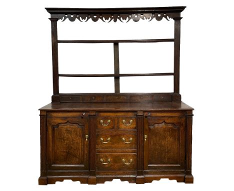 Late 18th century oak dresser and rack, the raised plate rack with projecting cornice over fretwork frieze and three heights,
