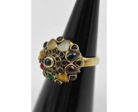 AN EASTERN STONE SET YELLOW METAL RING, size N 