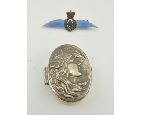 AN ENAMELLED SILVER RAF WINGS BROOCH, 4cm wide, together with an oval SILVER PILL BOX decorated with a repousse portrait of a