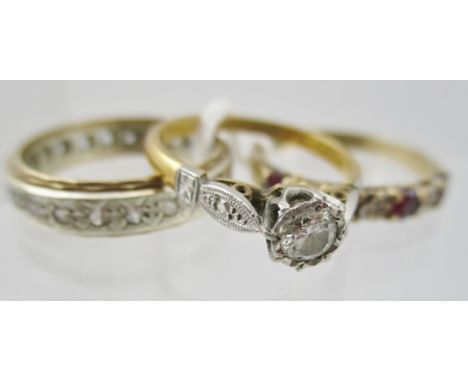 A DIAMOND SOLITAIRE RING set on an 18ct gold band, A 9CT GOLD DIAMOND ETERNITY RING and one other STONE SET RING (3) 