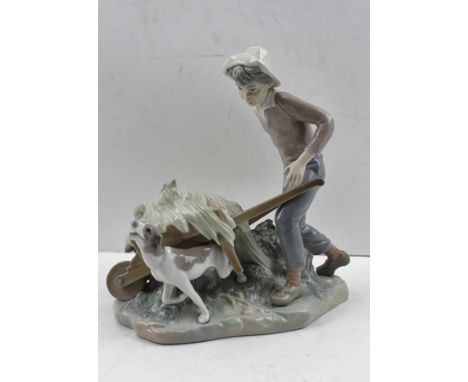 A LLADRO PORCELAIN FIGURE OF A BOY WITH WHEELBARROW AND HOUND factory marks to base, 22cm high 