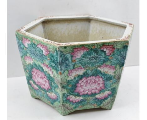 A 19TH CENTURY CHINESE CERAMIC JARDINIERE of tapering hexagonal form on lug feet, painted in the round with Lotus flower deco
