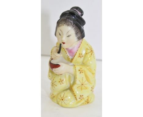 A ROYAL WORCESTER PORCELAIN CANDLE SNUFFER in the form of a kneeling bijin, in yellow kimono, bears factory mark inside, 7cm 