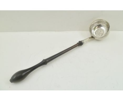 AN 18TH CENTURY LADLE, the bowl inset a Spanish two Real coin dated 1749, turned lignum vitae handle, 29cm long 