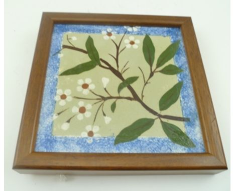A WEDGWOOD TILE designed by Lewis Foreman-Day, blossom sprig on a celadon green ground with sponge ware border, 15cm square, 