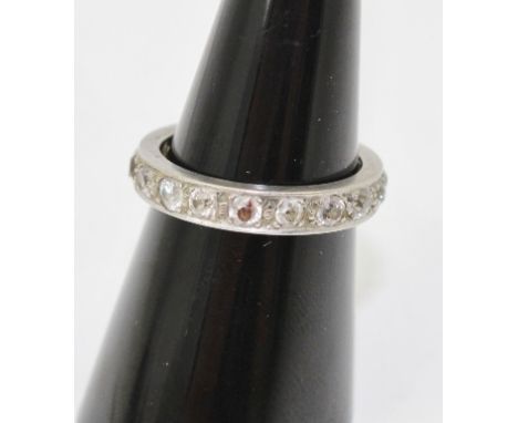 A DIAMOND ETERNITY RING set eighteen brilliant cut stones, in a white metal band, ring size M and half 