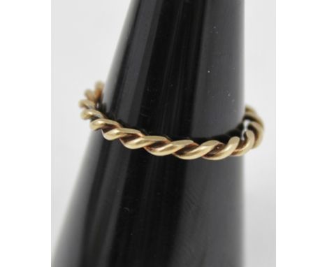 A YELLOW METAL RING of spiral twist form, size N and half 