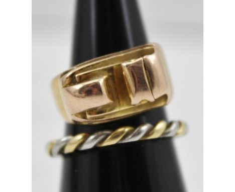 A YELLOW METAL CONTEMPORARY DESIGN RING of scrolling form, together with a BI-METAL ROPE TWIST FORM RING (2) 