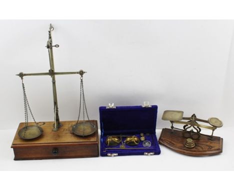 A LATE VICTORIAN AVERY OF BIRMINGHAM BRASS BALANCE SCALE on a mahogany box base fitted drawer, 26cm wide, together with a pos