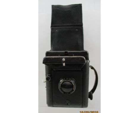 A "THORNTON PICKARD VICTORY REFLEX" CAMERA with a "T.P. Cooke anastigmat lens T.T. and H. Ltd., 5 inches f/4.5, no.86282" 