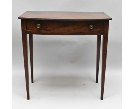 A LATE GEORGIAN MAHOGANY BOW FRONT SIDE TABLE, having plain top with reeded edge, single full width drawer, supported on plai