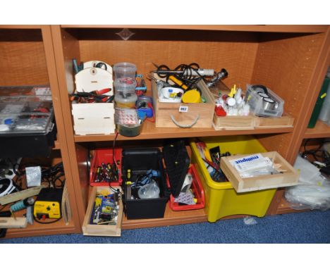 A SELECTION OF TOOLS AND GLUES including soldering irons, a multimeter, various pliers, screwdrivers, lamps, a fan, tie wraps