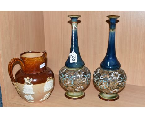 A PAIR OF DOULTON LAMBETH SLATER'S PATENT VASES AND A DOULTON LAMBETH HARVEST JUG, each vase with a narrow, elongated neck an