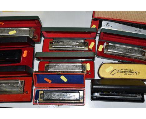 A GROUP OF TEN CASED HOHNER HARMONICAS, comprising The 64 Chromonica professional model, a CX12, a CBH Professional 2016, fou