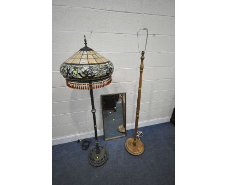 A TIFFANY STYLE STANDARD LAMP, with a cream and foliate decorated shade, on a metal support and base, labelled kind light man