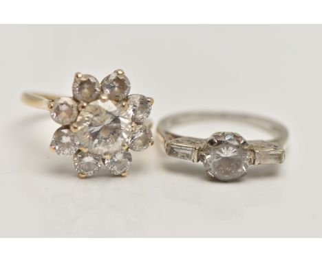 TWO 9CT GOLD CUBIC ZIRCONIA SET RINGS, the first a circular cluster design, the second a three stone ring, both with 9ct hall