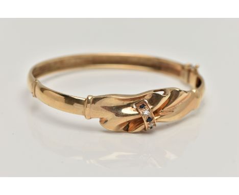 A 9CT GOLD HINGED BANGLE, gathered swag detail, set with three circular cut blue sapphires and two colourless cubic zirconia,