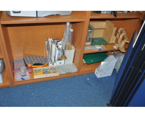 A SELECTION OF MODEL MAKING CONSUMABLES AND ACCCESSORIES including vinyl skins, packs of nuts and bolts, model stands, a tool