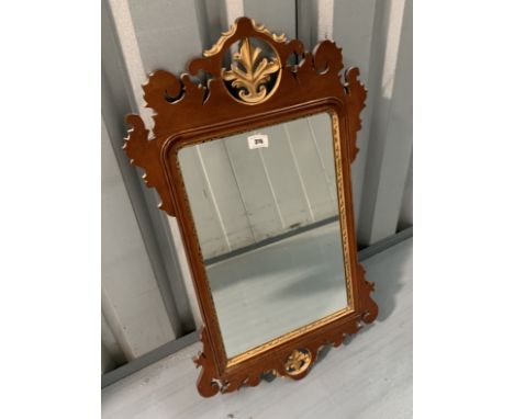 Chippendale style mahogany wall mirror with gilt painted slip and detail. 29” high, 17.5” wide
