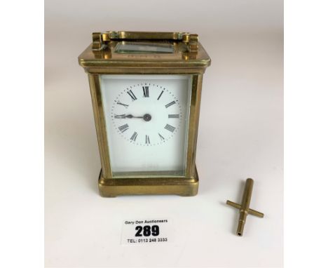 Brass carriage clock by R &amp; Co. Paris. 4.25” high plus handle. Working with key