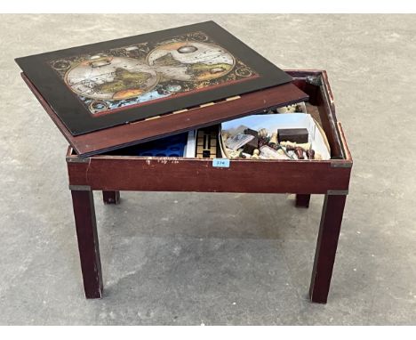A games table with chessboard and glass top enclosing gaming pieces. 26" wide