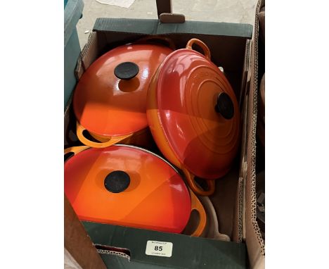 A box of Le Creuset and Cousances cookware