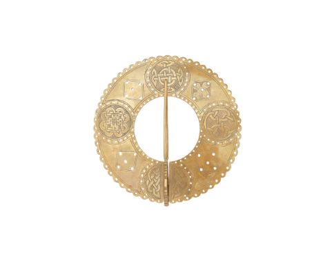 A BRASS PLAID BROOCH 18TH CENTURY of large annular form, the outer arched and pierced borders enclosing four Celtic knot boss