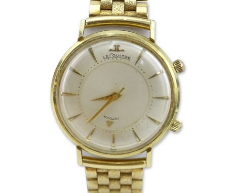 Jaeger LeCoultre Memovox 14 Karat Yellow Gold Watch. Silvered dial with applied baton markers and sweeping center seconds. St