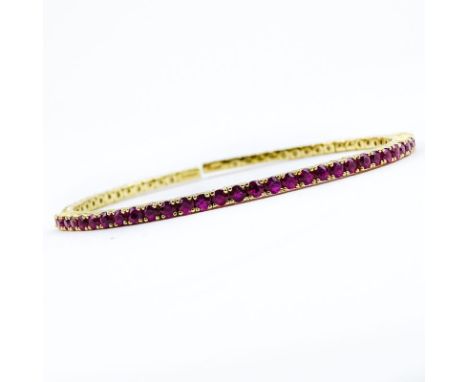 Vintage Round Brilliant Cut Ruby and 14 Karat Yellow Gold Flexible Cuff Bangle Bracelet. Rubies with vivid saturation of colo