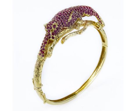 Approx. 13.0 Carat Pave Set Burma Ruby and 14 Karat Yellow Gold Panther Hinged Bangle Bracelet. Rubies with vivid saturation 