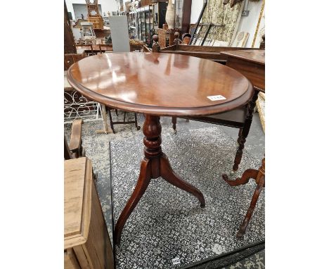 A 19th century mahogany tripod table and a later oak tea trolly.