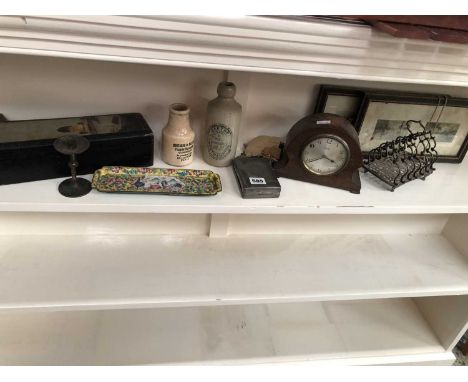 A mantle clock, two stoneware bottles, an enamelled tray etc.
