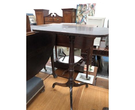 A George III mahogany tripod table with a rounded rectangular top