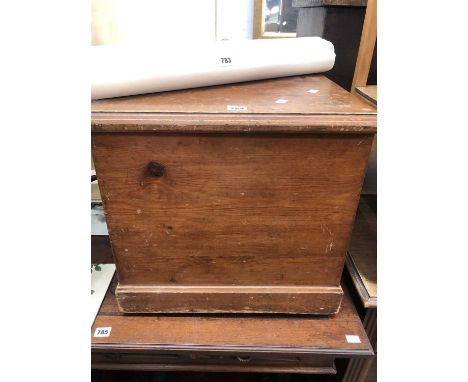 A pine commode with a ceramic liner