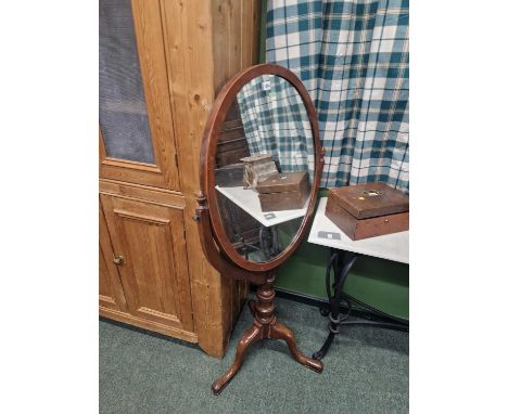 An unusual cheval mirror on tripod stand.