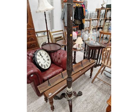 A large standard lamp on claw and ball tripod legs.