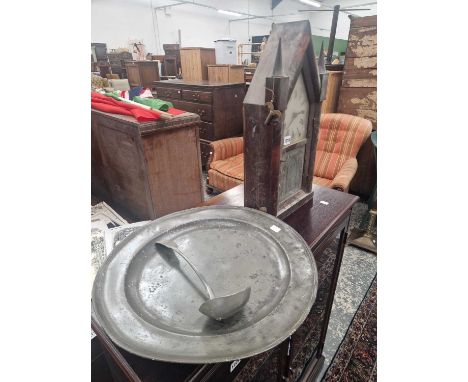 A Victorian american mantle clock , a large pewter platter and a ladle.