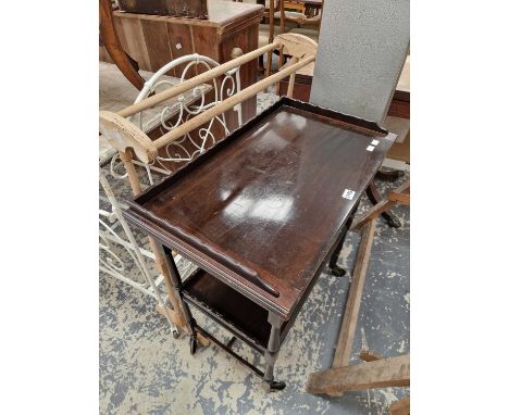 An early 20th century mahogany serving trolly with fold over card table top. together with a pine towel rail.