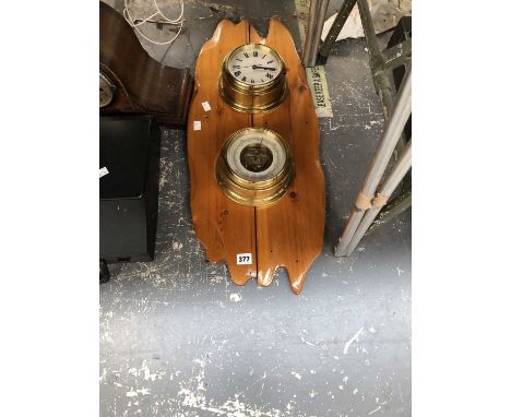 A pine board mounted clock and aneroid barometer, another clock and a typewriter