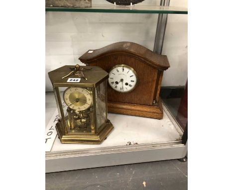 A glazed brass cased rotary clock together with an oak cased mantel clock