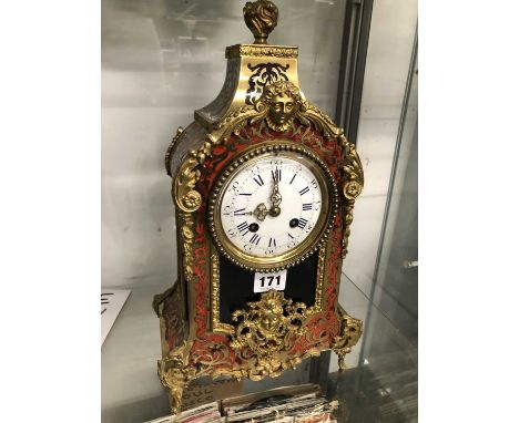 A Boulle mantel clock strking on a bell, the enamel dial with Roman numerals. H 39cms