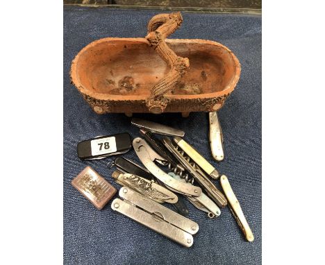 An interesting terracotta trug form basket and a quantity of pocket knives. 